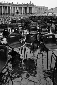 Empty wet chairs at st peter basilica