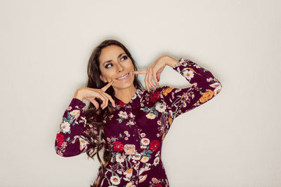 Smiling woman standing against white background