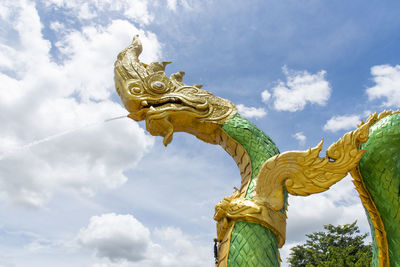 Low angle view of statue of angel against sky