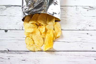 Potato chips and pack. packaging of chip on white background. top view.