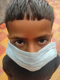 Close-up portrait of mid adult woman covering face