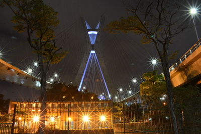 Low angle view of illuminated street lights at night