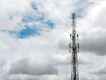 Low angle view of electricity pylon against sky