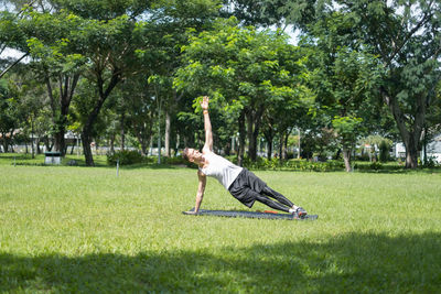 Full length of man exercising at park