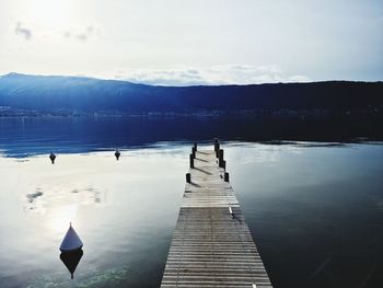 Pier on lake against sky