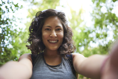 Self-portrait of a woman in a forest.