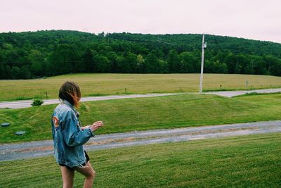 Young woman smoking in field