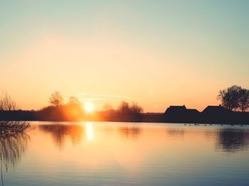 Scenic view of lake against sky during sunset