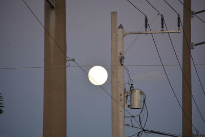 Low angle view of illuminated street light against sky