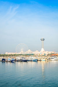 View of ferris wheel in city against sky