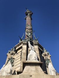 Low angle view of columbus monument against blue sky in barcelona 