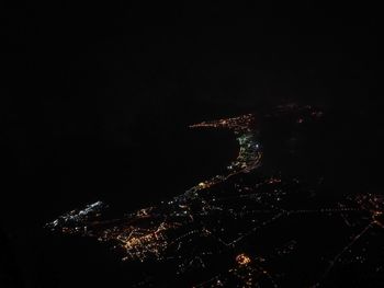 Illuminated cityscape against sky at night