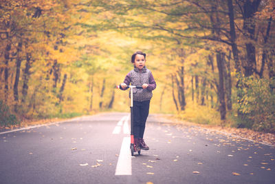 Full length portrait of man standing on road