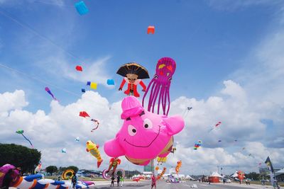 Low angle view of balloons flying against sky