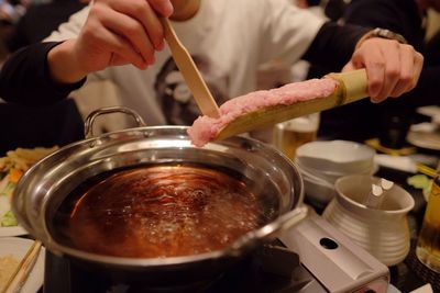 Cropped image of hand preparing food