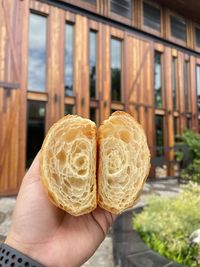 Close-up of person holding croissants 