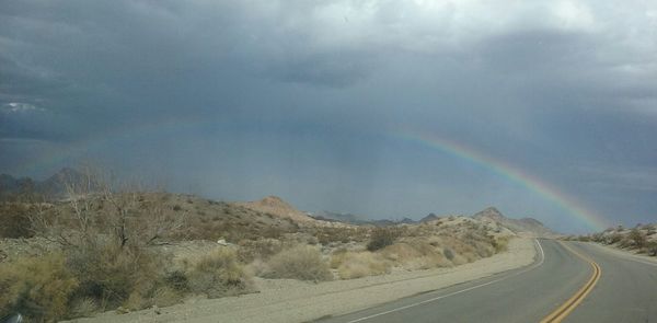 Scenic view of mountains against cloudy sky