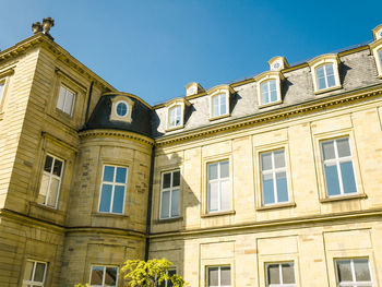 Low angle view of building against clear blue sky