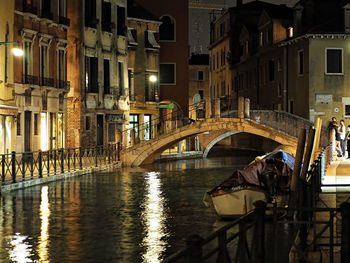 View of boats in city at night