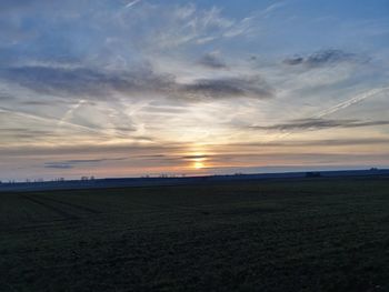 Scenic view of field against sky during sunset