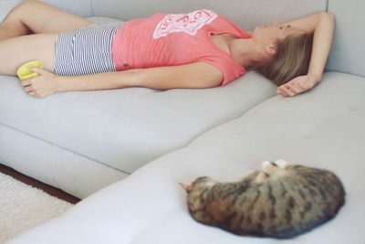 High angle view of woman lying on bed at home