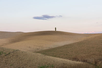 Scenic view of land against sky during sunset