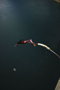 Bungee jumping over calm sea