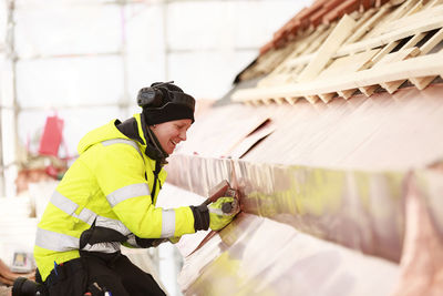 Woman working on roof