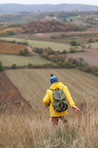 Person with umbrella on field