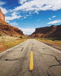 Empty road with mountain in background