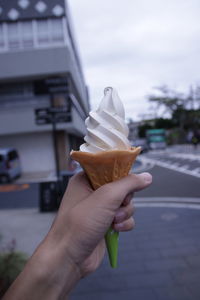 Hand holding ice cream cone