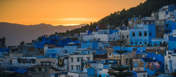 Panoramic shot of cityscape against sky during sunset