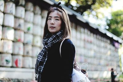 Portrait of young woman standing outdoors