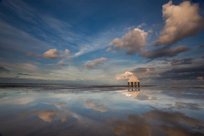 Gazebo at beach against sky