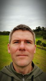 Portrait of man on field against sky