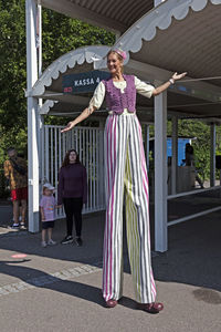 Portrait of a woman standing against built structure