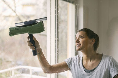 Woman cleaning glass window