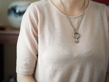 Midsection of woman wearing necklace