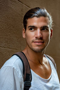 Portrait of young man against wall