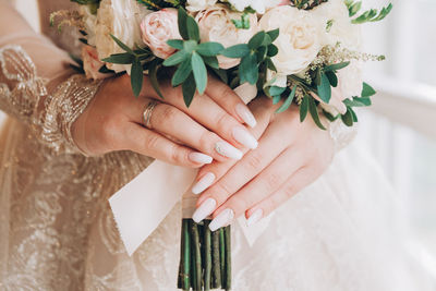 Midsection of woman holding bouquet