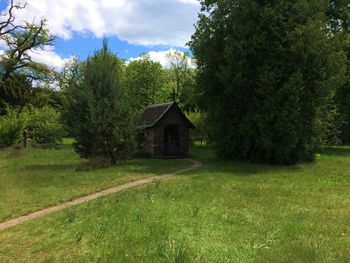 Built structure on grassy field against sky