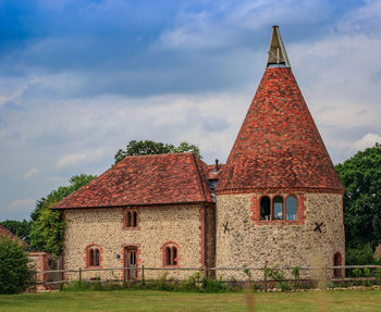 Exterior of house on field against sky