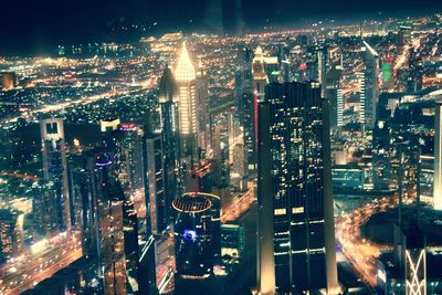 High angle view of city lit up at night