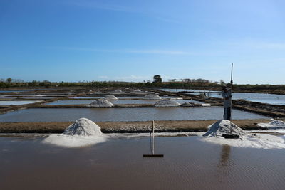 Man working standing at salt mine