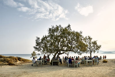 People on beach against sky