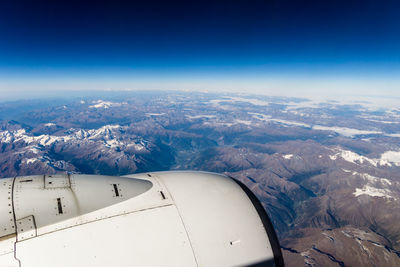 Aerial view of mountains against clear blue sky