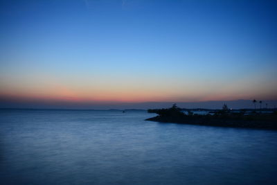 Scenic view of sea against sky at sunset