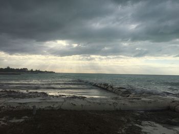 Scenic view of beach against sky during sunset