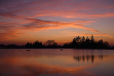 Scenic view of lake against romantic sky at sunset