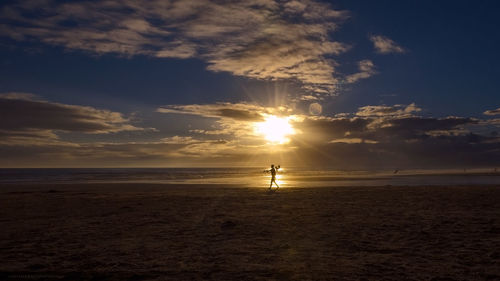 Scenic view of beach against sky during sunset